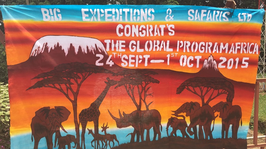 A colorful banner is seen with silhouettes of African animals. 