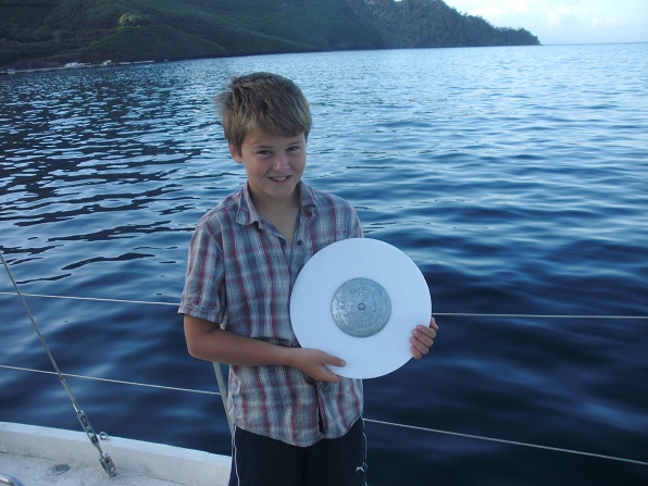 Holding a secchi disk.  Photo courtesy of Janis Steele.