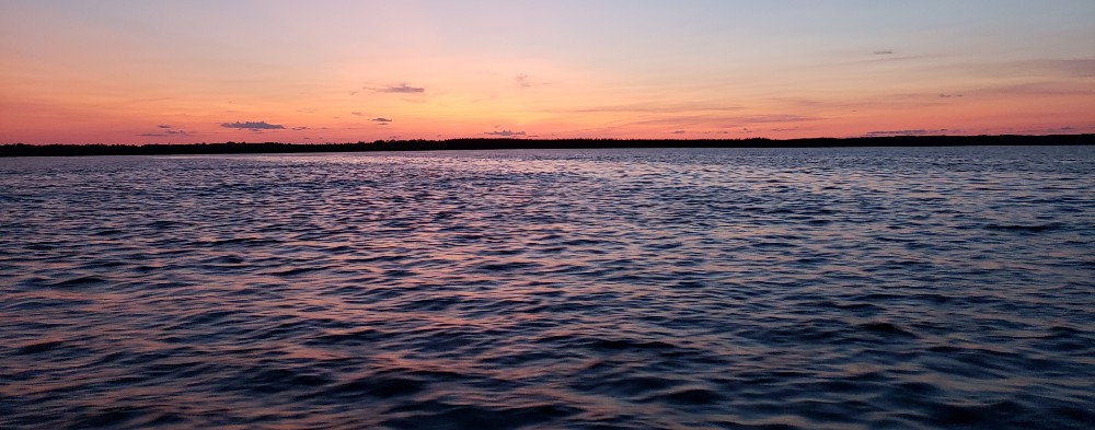 Large body of water at sunset.