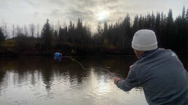 Nathanael collecting water samples at Site 5