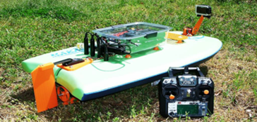 Image of an AquaROVER and its remote control on grass.