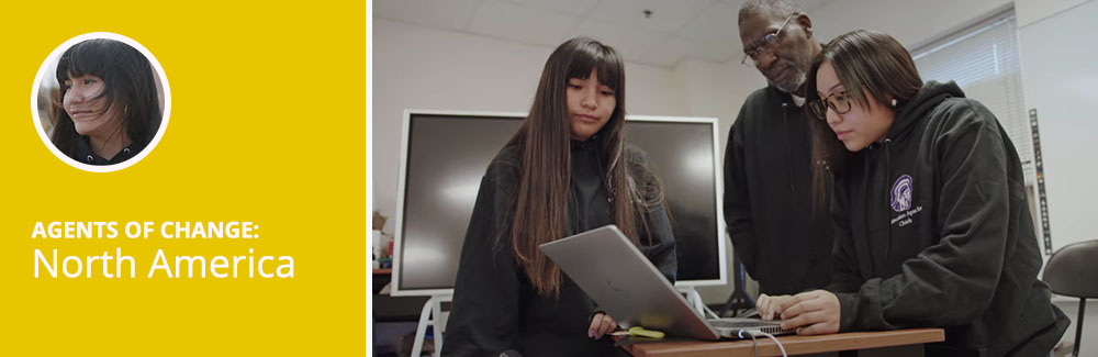 Two students and a teacher look at a computer in class. Text reads: Agents of Change: North America