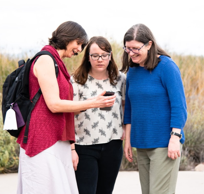 Group looking at a mobile device.