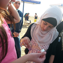 Several students take measurements together.