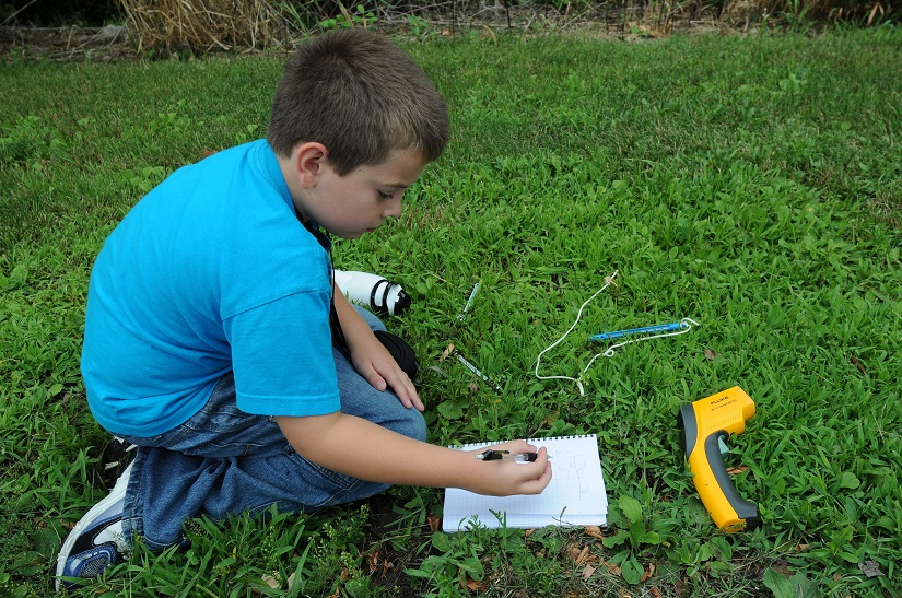 A student writes down surface temperature observations