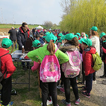 Students gather around a table looking at educational materials.