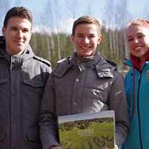 Three students stand together for a photo.