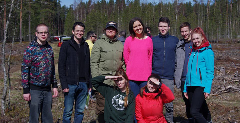 Teachers and students pose together for a group photo.