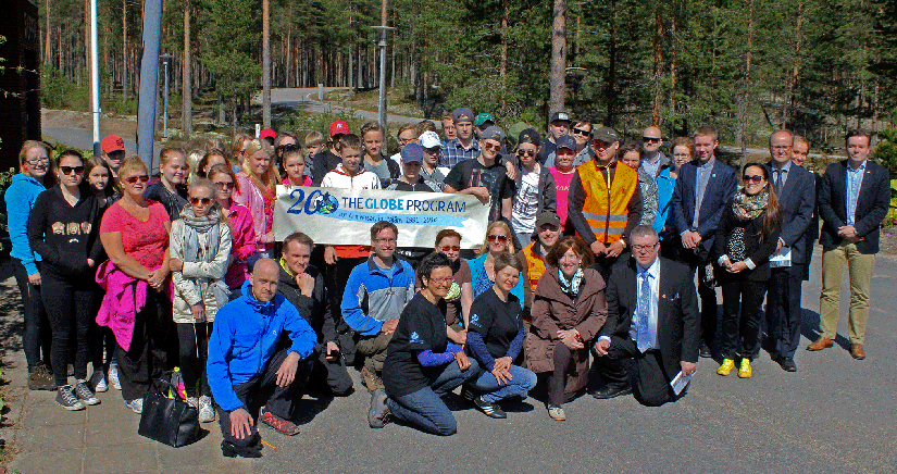 A large group of people standing or kneeling next to a banner that reads "20 The  GLOBE Program".