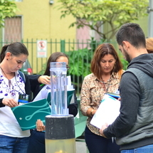 Participants standing outside looking at notes.