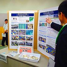 A student giving a poster presentation.