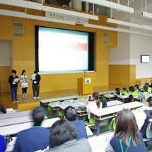 Students on stage giving an oral presentation.