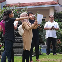 Girls looking at a document and pointing.