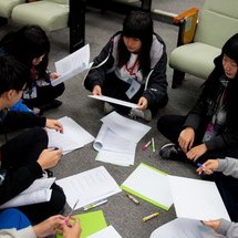 Student sitting in a group having a discussion.