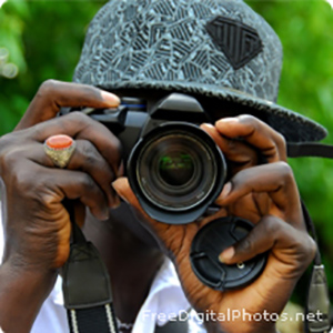 A boy with a camera taking a picture.