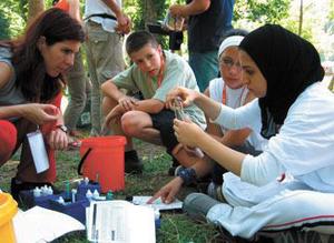 Student sitting together doing measurements.