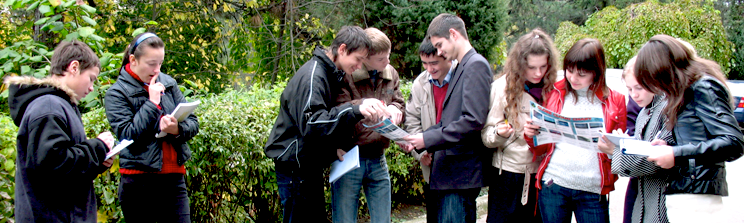 Students outside looking over GLOBE worksheets.