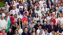 A large group stands together for a photo.