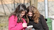 Two women look at a data taking tool.