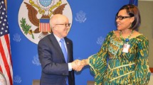 U.S. Embassy representative shaking hands with Liberia's Ministry of Education Representative.