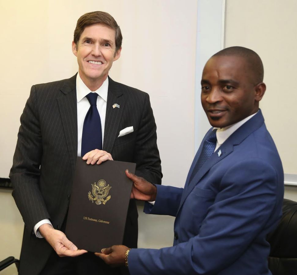 Minister of Basic Education, Honorable Bagalatia Arone (right) and Ambassador Miller (left) hold the signed GLOBE Agreement.