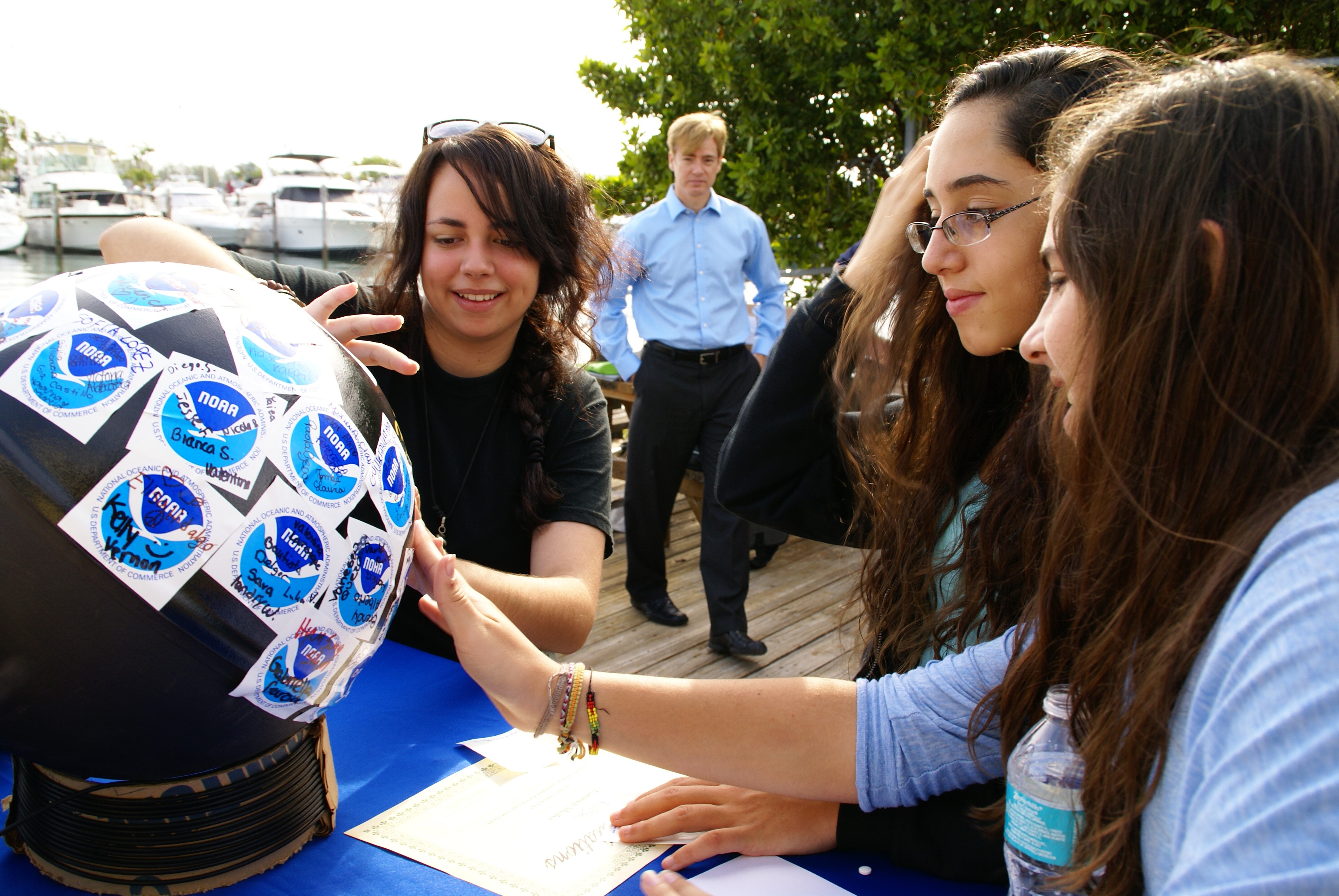 People engaged in the NOAA Adopt a Drifter Program