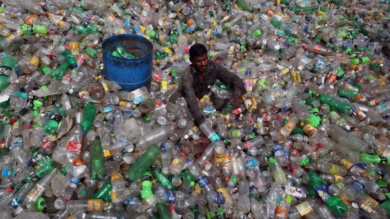 World Environment Day photo of a man sitting in a pile of plastic