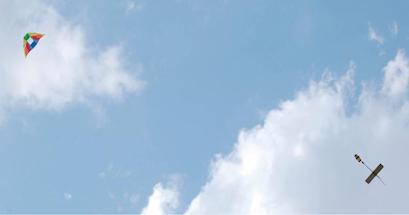 Kite and aeropod in blue sky.