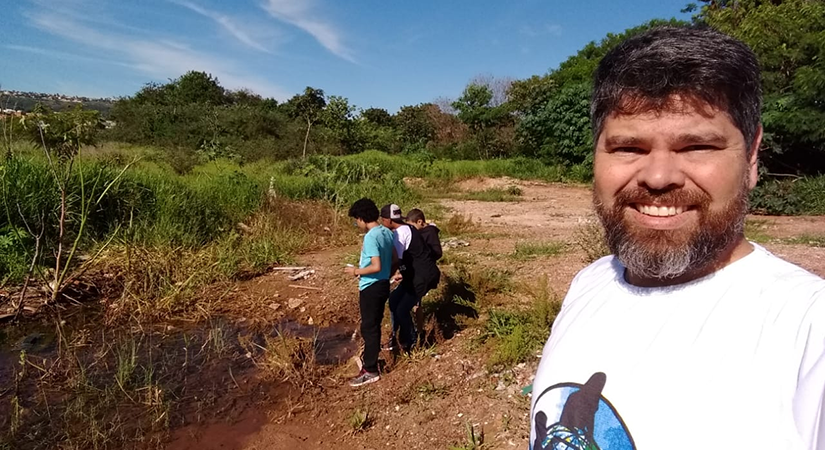 A man takes a selfie out of doors.