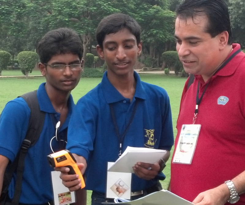 Image of a teacher explaining an instrument to two students