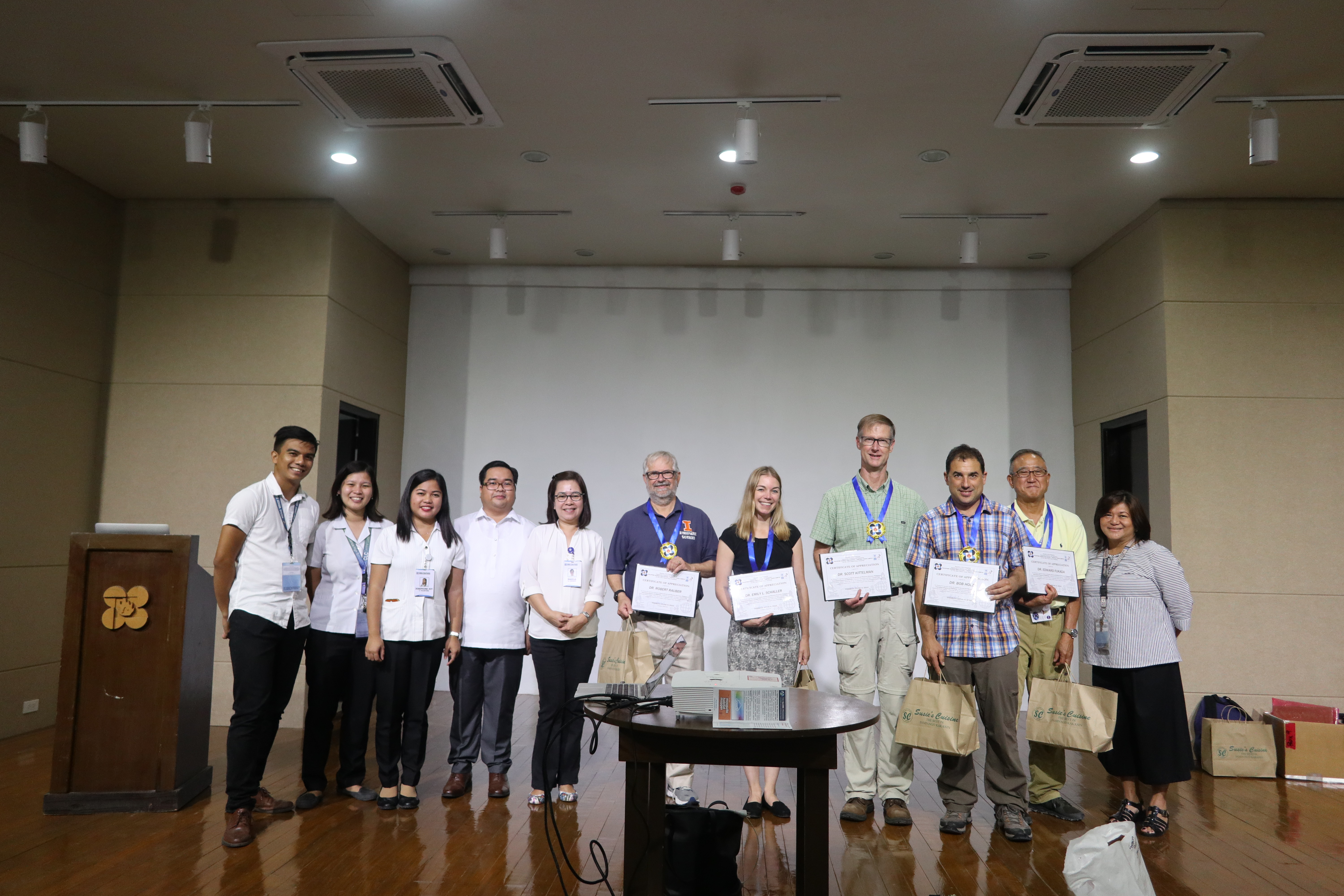 Philippine Science High School Central Luzon Campus (PSHS-CLC) director, Theresa Diaz (right) and teachers pose with NASA CAMP2Ex team holding certificates of appreciation after their presentation at the school on 09 September 2019.