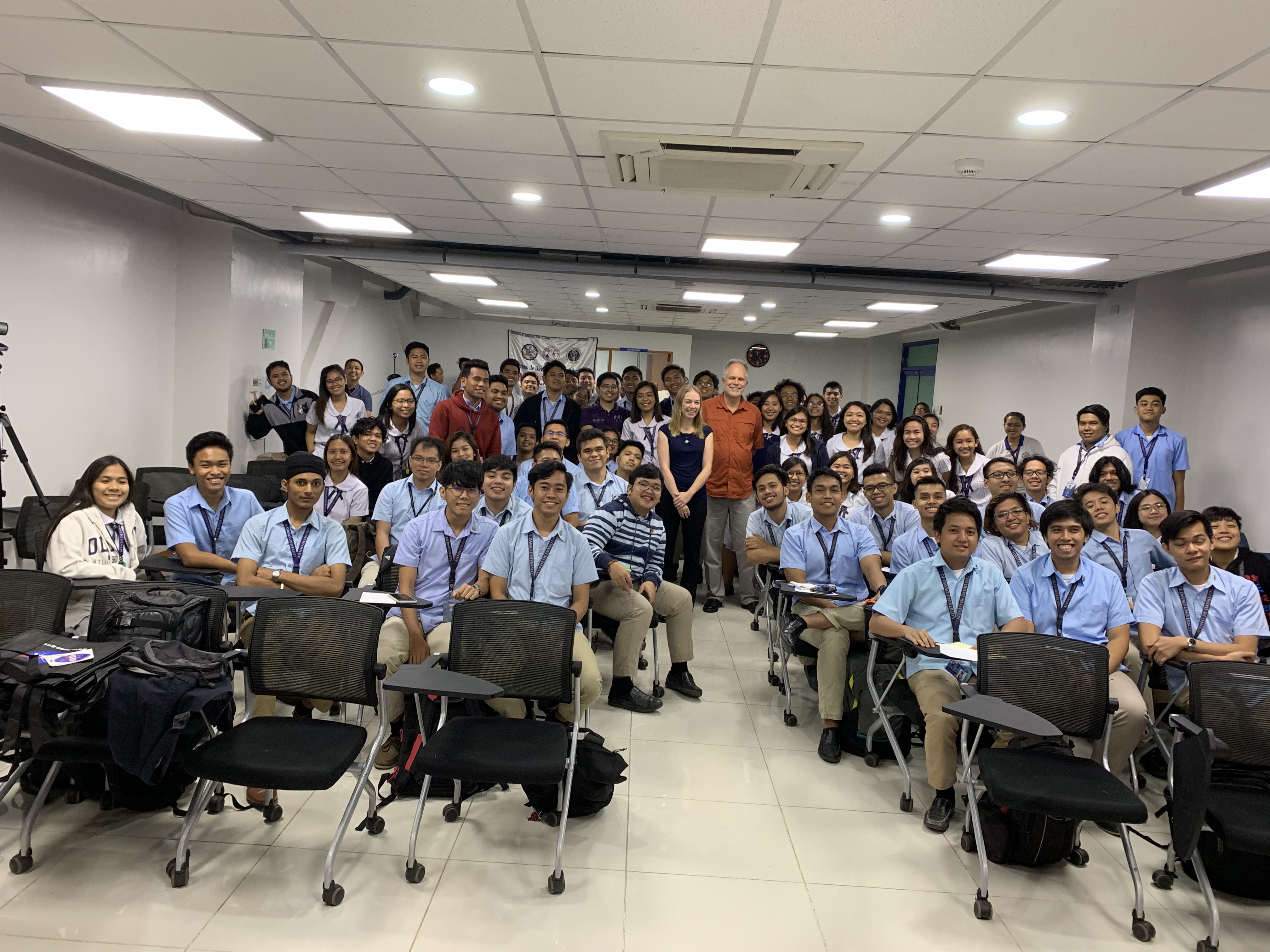 Emily Schaller and Hal Maring pose with 1st and 2nd year university students at Ateneo de Davao University.