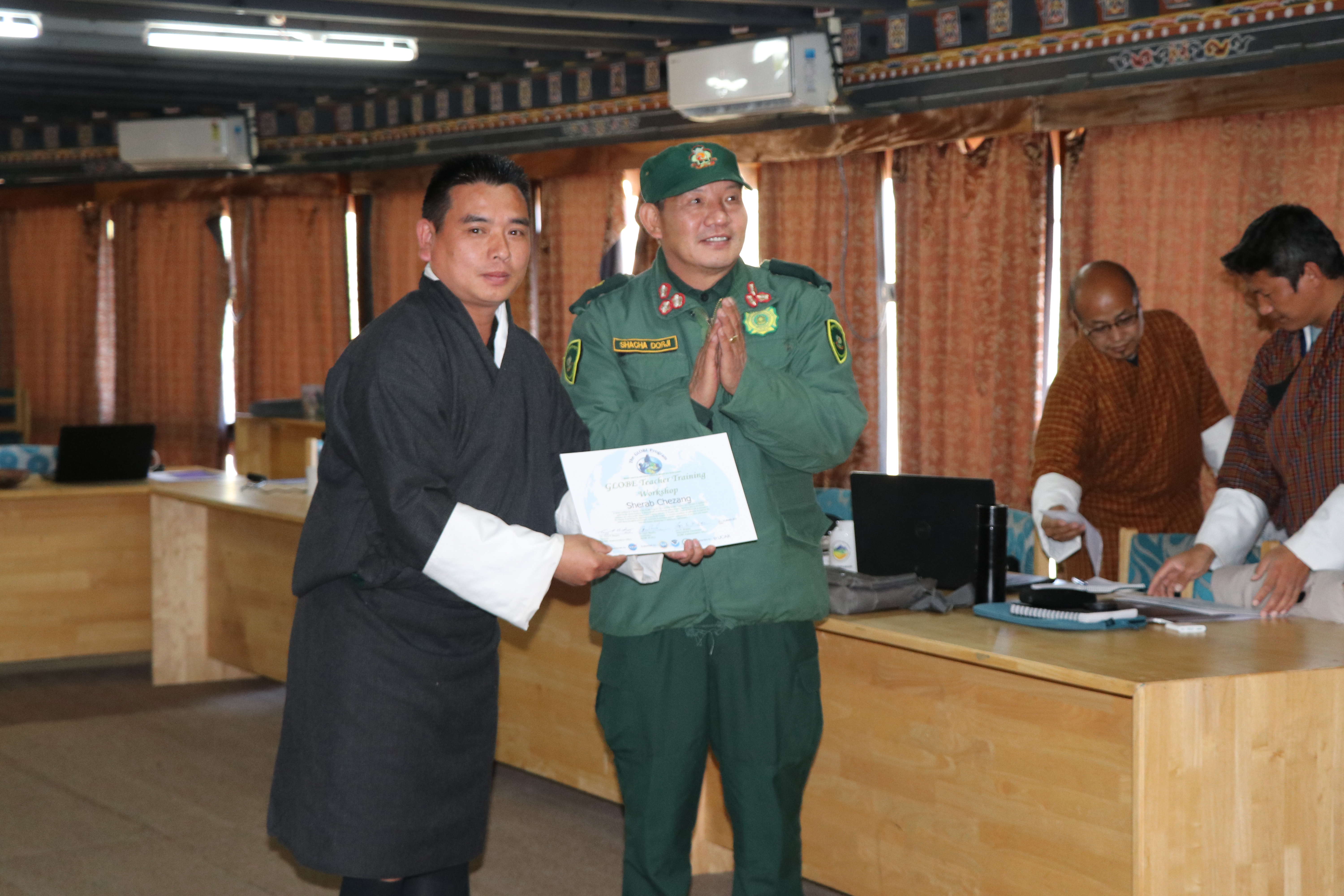 Director Shacha Dorji, Ugyen Wangchuck Institute for Conservation and Environment Research,   presenting teachers with GLOBE teacher training certificate  