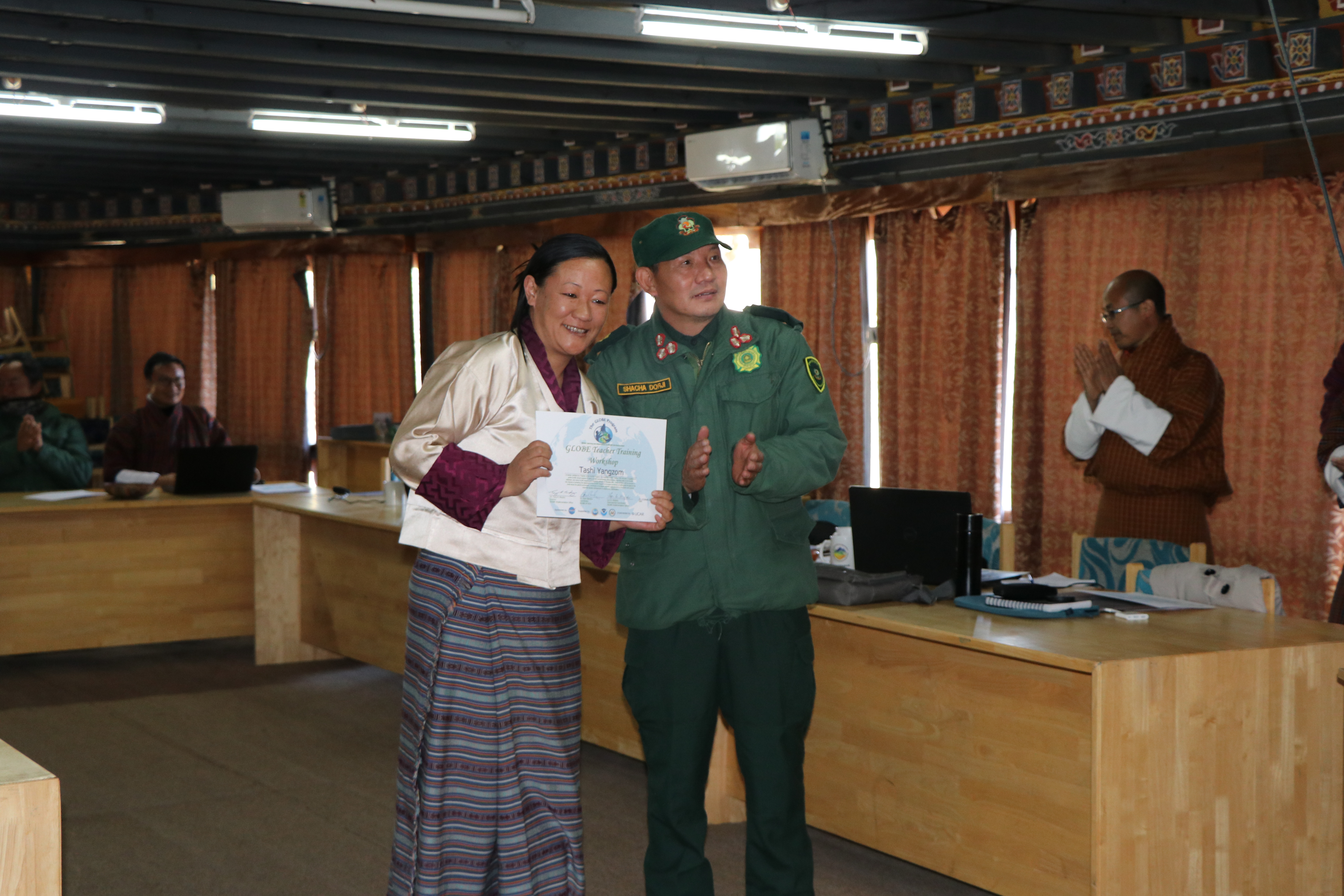 Director Shacha Dorji, Ugyen Wangchuck Institute for Conservation and Environment Research,   presenting teachers with GLOBE teacher training certificate  