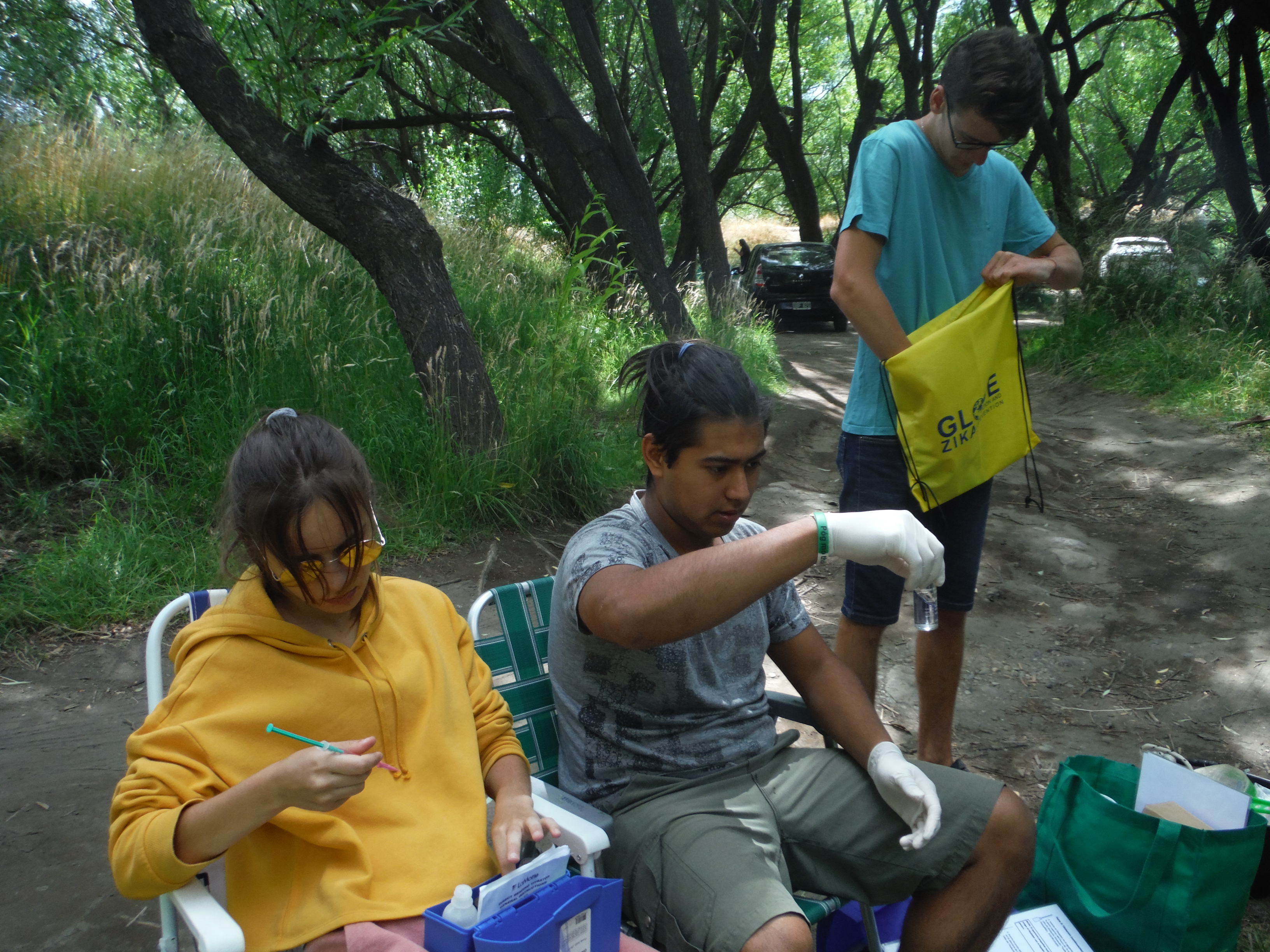 Photo of GLOBE Argentina students Marianela P., Juan W., and Lucio M., studying out in the field. e Argentine Junior Water Prize (organized by the Argentine Association of Sanitary Engineering and Environmental Sciences). The students will represent the country in the Stockholm Junior Water Prize competition organized by the Stockholm International Water Institute (SIWI) within the framework of the World Water Week in Sweden.  The Stockholm Junior Water Prize is a competition for students between the ages of 15 and 20 who have developed water-related projects. Students from 38 countries participate. The overall winner of the competition will be chosen by a jury of international experts, and will be announced in on 24 August 2021 by Her Royal Highness Crown Princess Victoria of Sweden.   The students used GLOBE’s hydrosphere and biosphere protocols, along with The GLOBE Program’s app, GLOBE Observer (GO) Mosquito Habitat Mapper (MHM), in order to conduct the investigation “Characterization of the larval habitat of mosquitoes in Northern Patagonia, Argentina.”