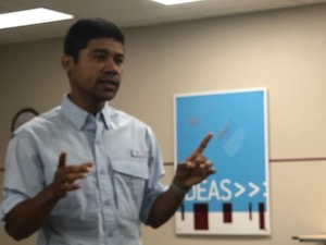 A man is pictured talking in a classroom setting.