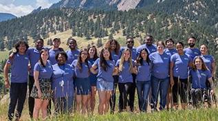 A photo of a group of SOARS Proteges in front of the Boulder Flatirons (mountains)