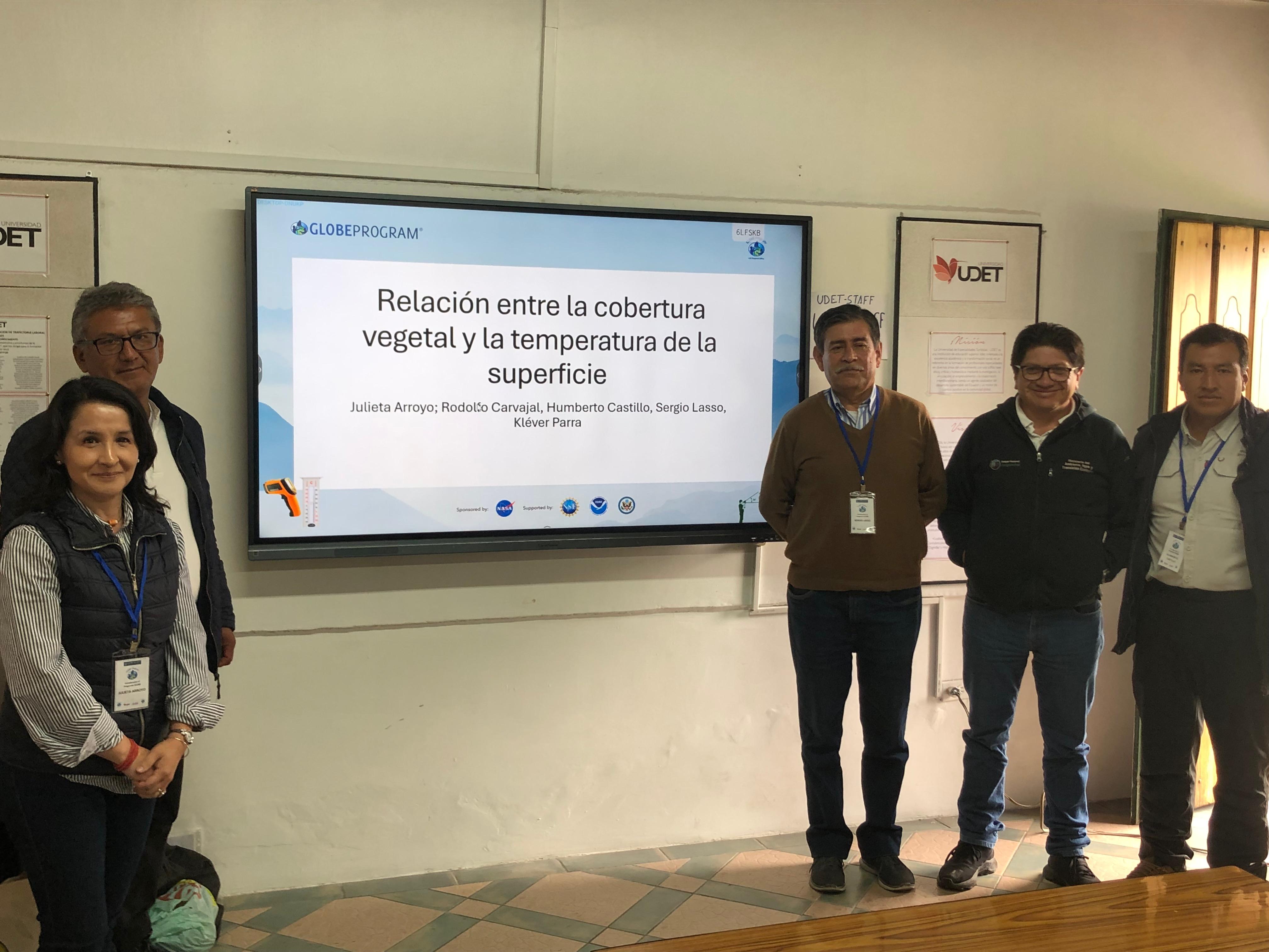 Group of people standing by presentation.