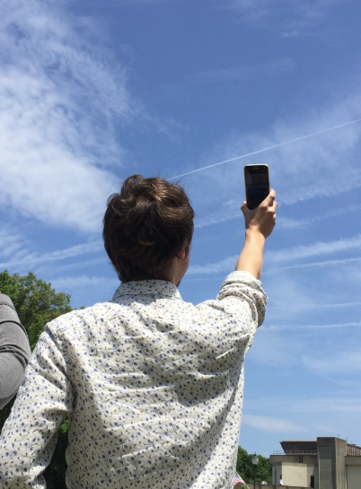 Photo of a person taking data of a contrail