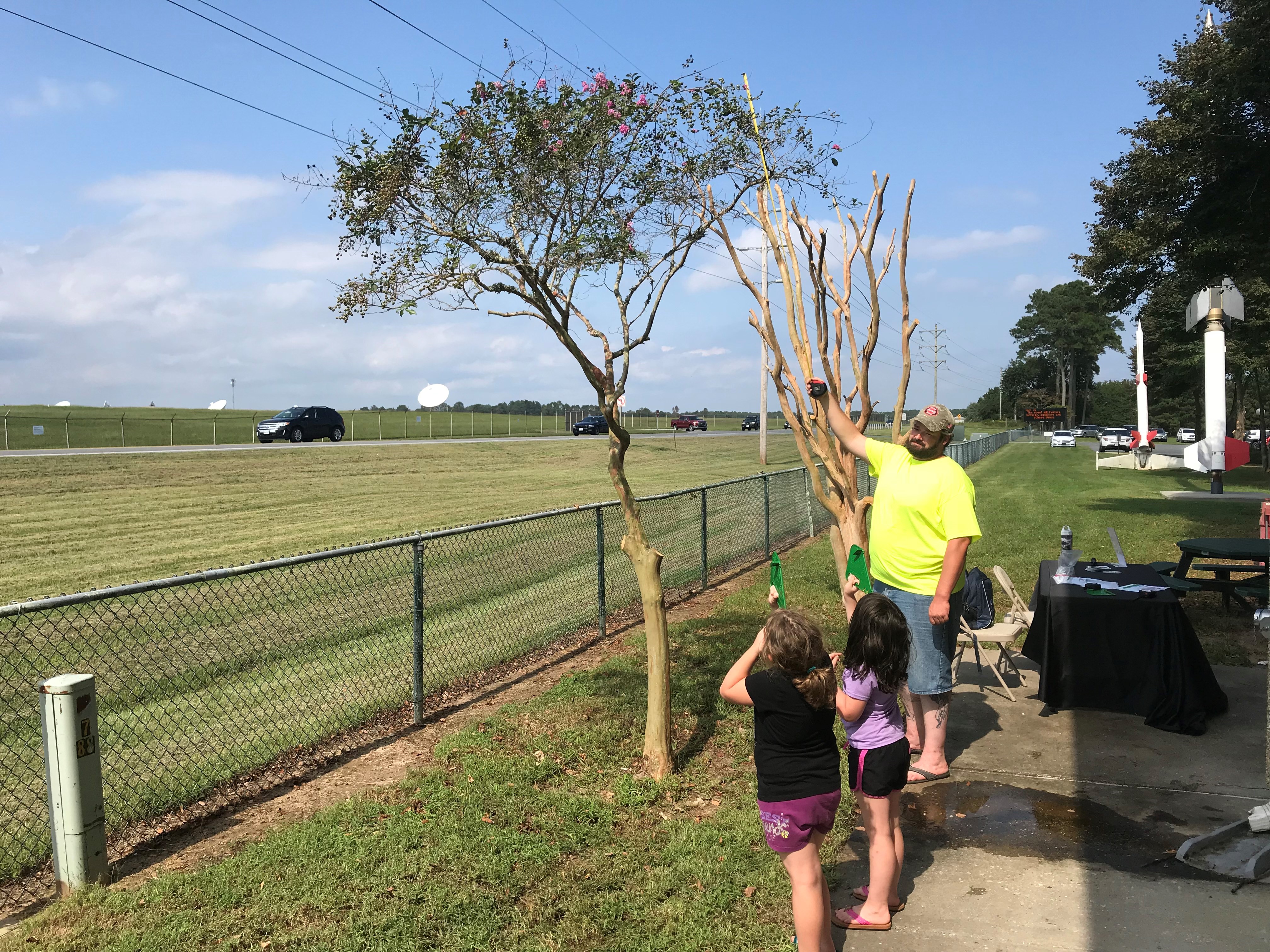 Elementary school students taking a tree height measurement. Image Credit: Brian Campbell