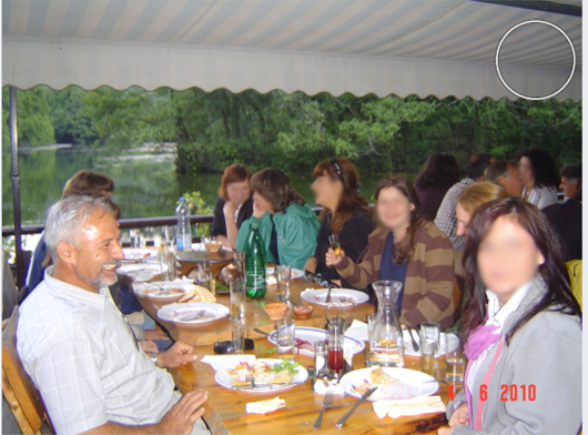 Group sitting at table eating.
