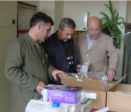 Three people opening boxes of equipment.