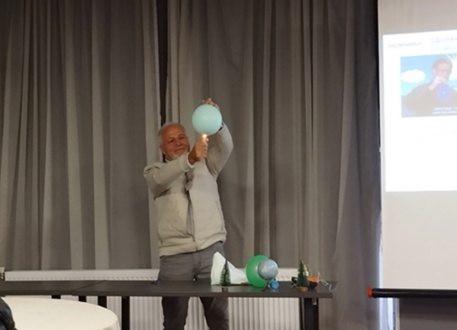 Man demonstrating globe protocols with a balloon and flame.