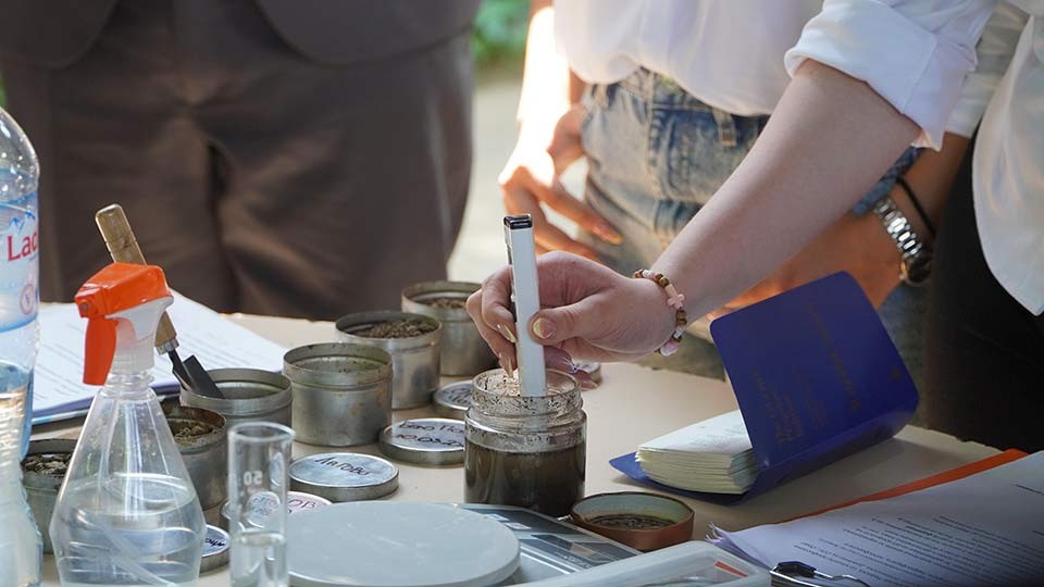 Person testing soil.