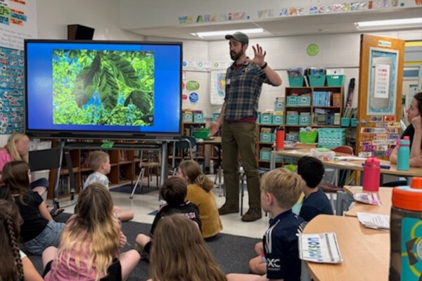 Forester speaking with classroom about leaves.