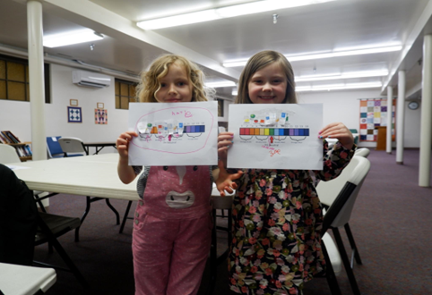 Two kids holding pH scales.