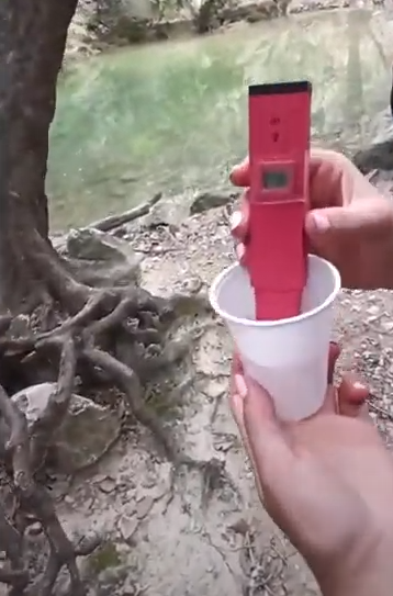 Photo of a student taking a water temperature reading