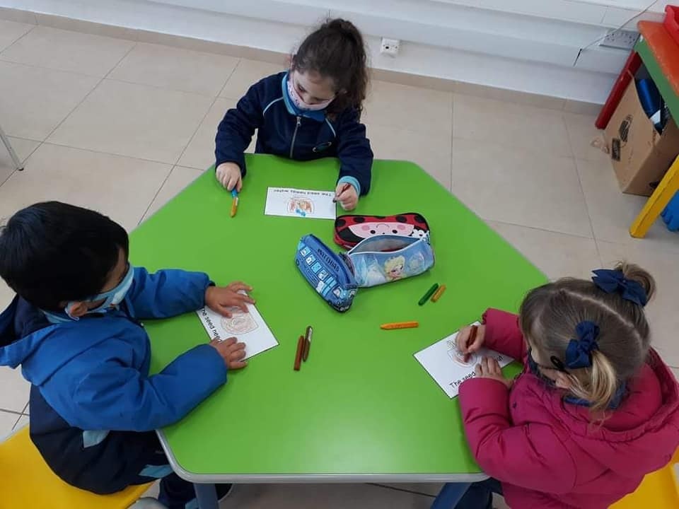 Three Kinder 1 students (Gozo, Malta) learning about the life cycle of a plant