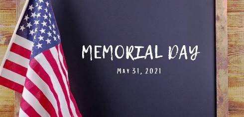 A photo of a U.S. flag, and a chalkboard that reads "Memorial Day 2021"