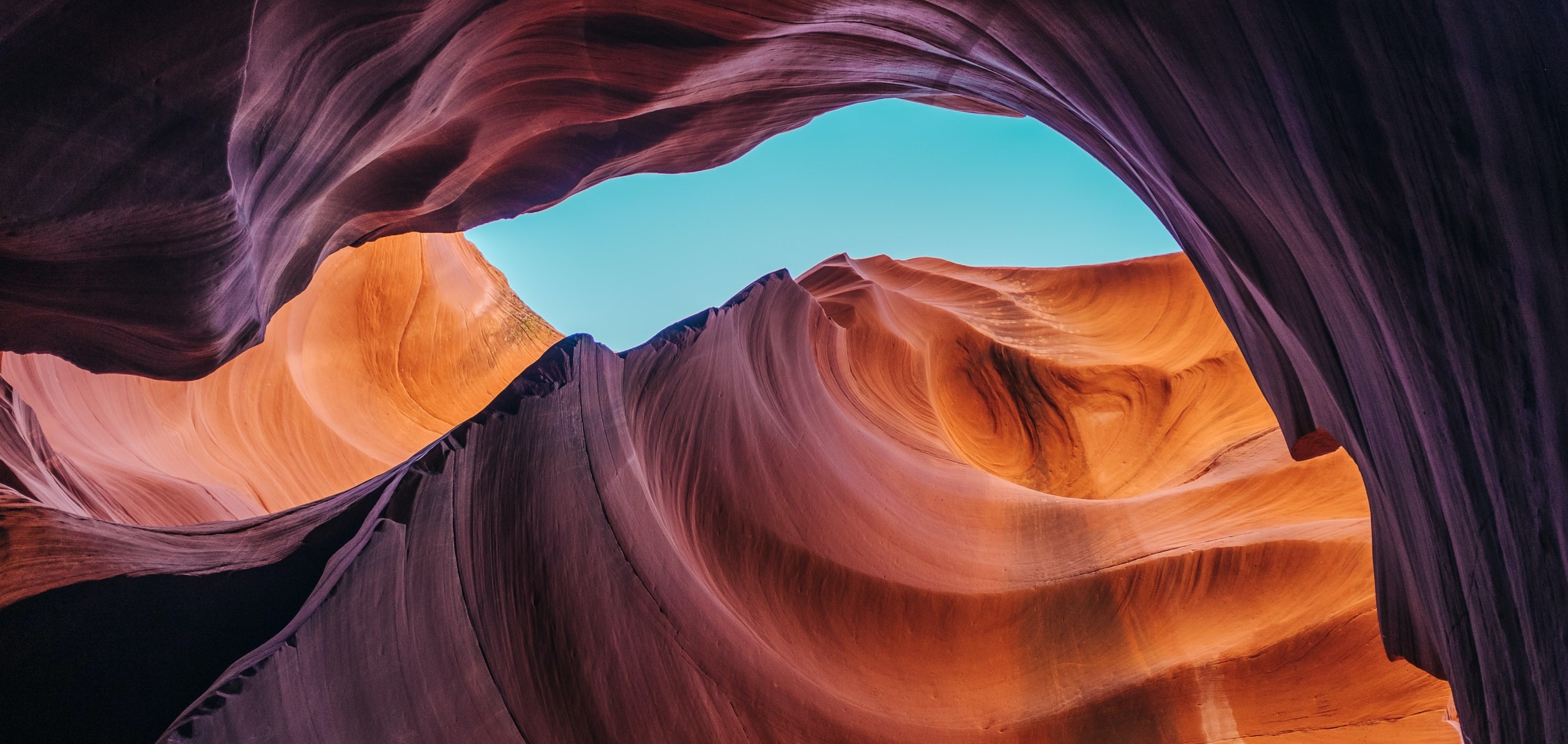 A photo of a swirling red rock canyon